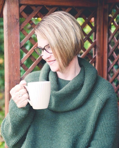 Image of Anna Hiett, Sales Training Consultant and Executive Coach holding a mug and smiling.